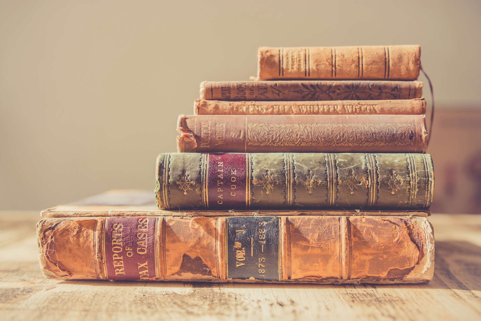 Stack of old books on wooden table